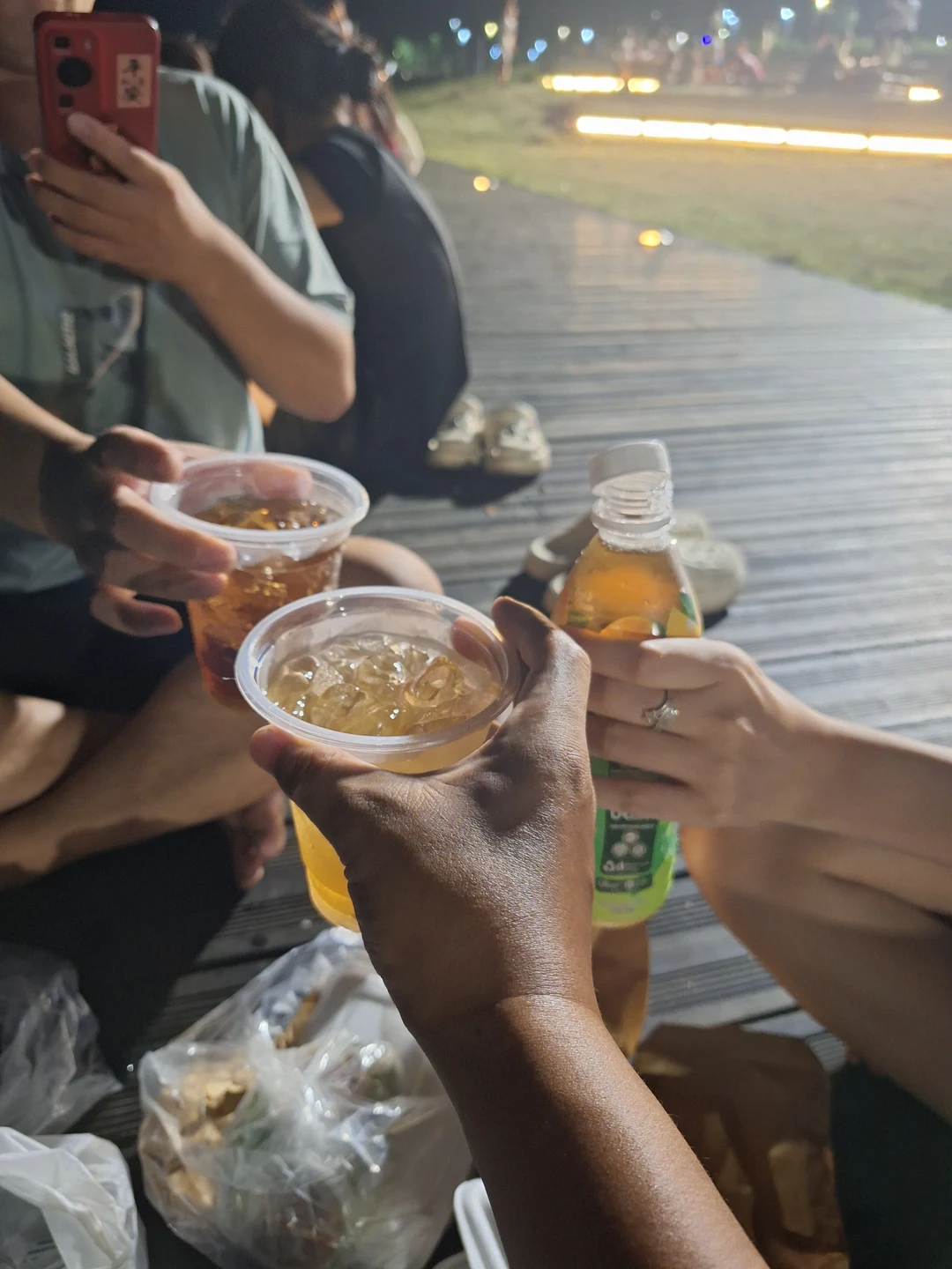 Evening Gathering by the Perfume River · Toasting iced drinks on the wooden boardwalk