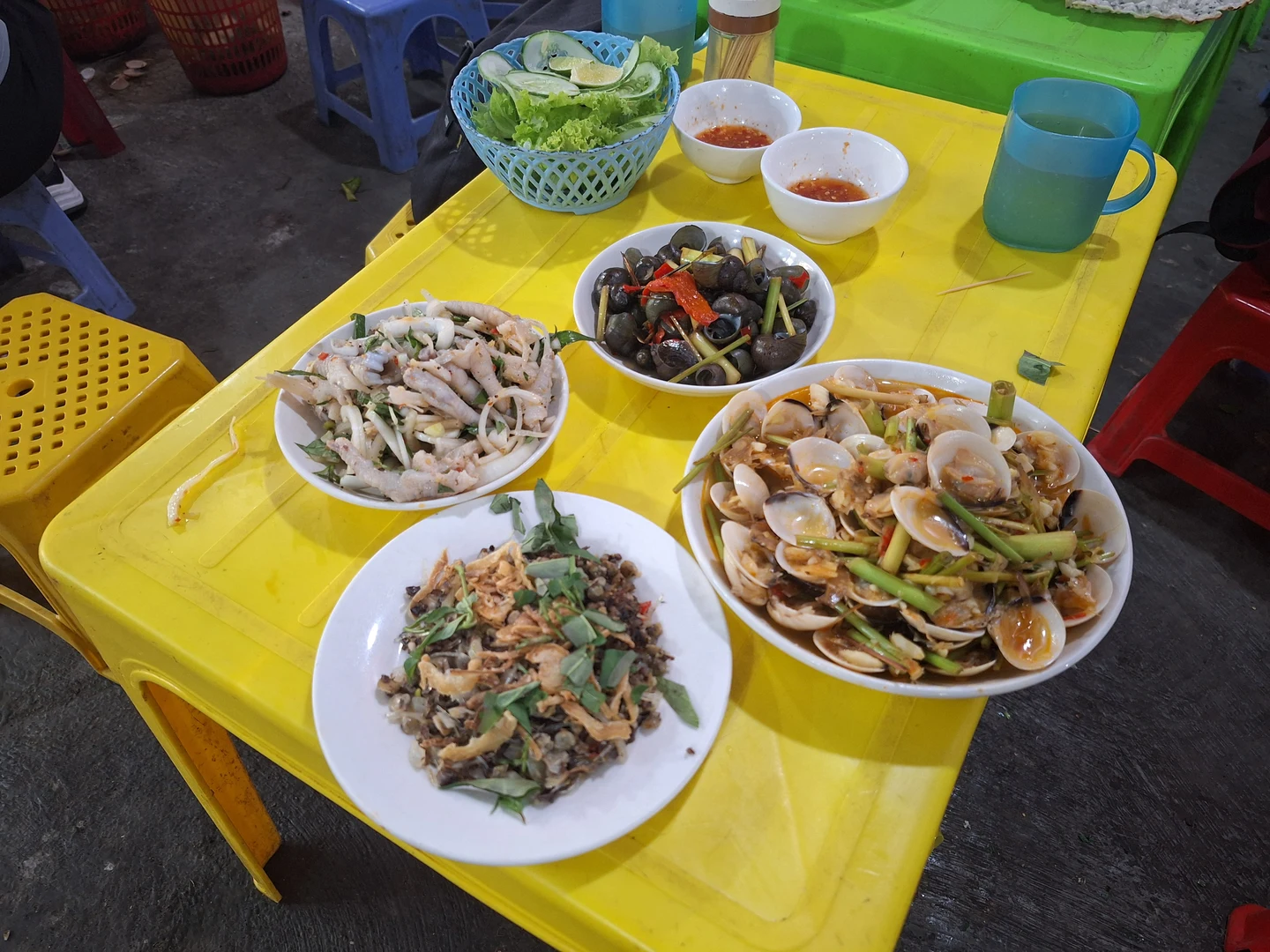 Street Seafood Stall in Hue · Authentic flavors on yellow plastic tables