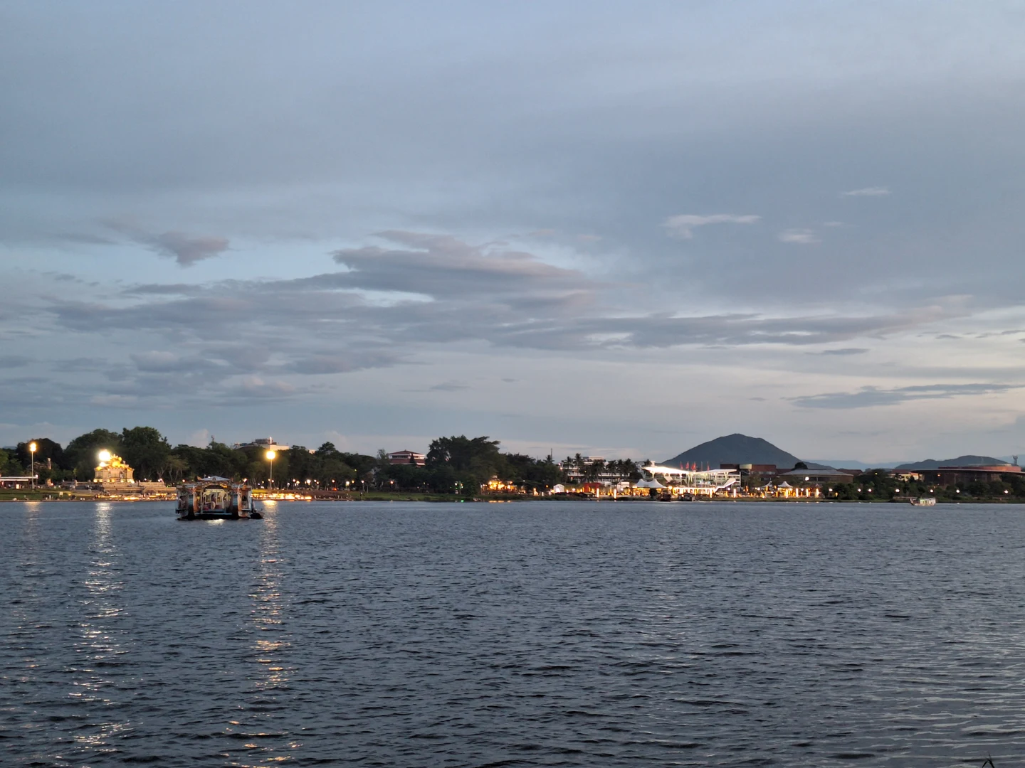 Sunset Dragon Boats on the Perfume River · Gentle twilight glow across wide water