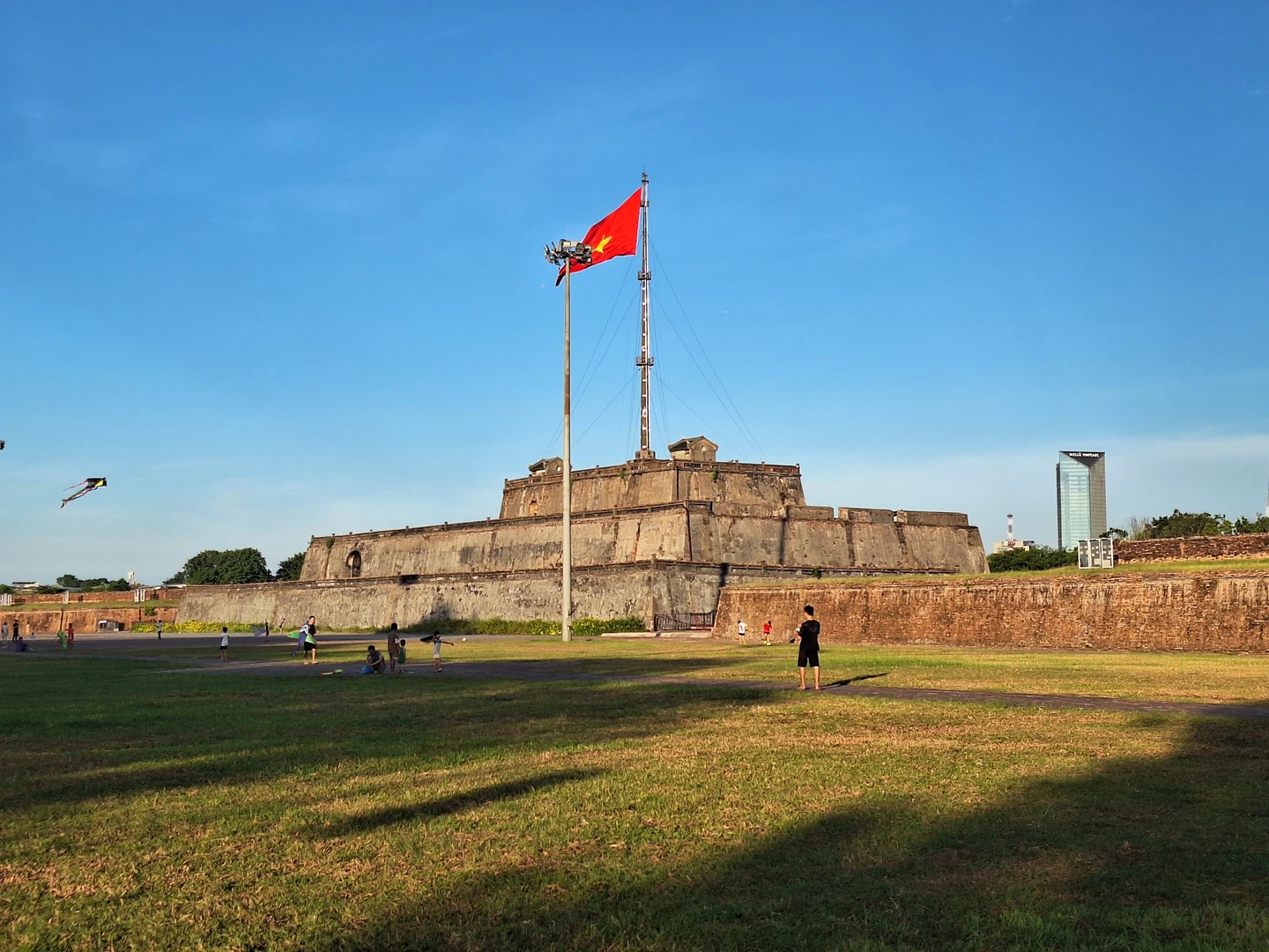 The Grand Esplanade Before the Imperial City · Expansive royal plaza stretching before ancient citadel